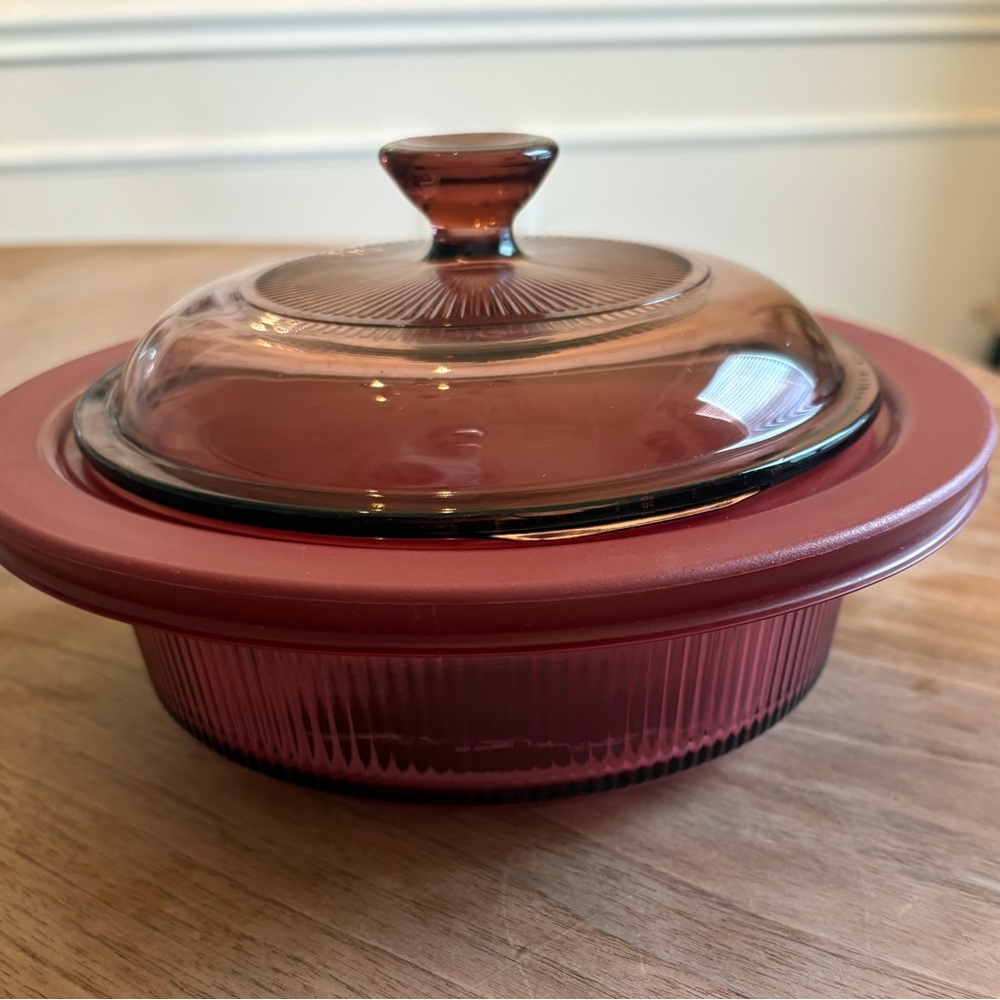 Vintage Corning ware vision cranberry casserole dish with two lids.